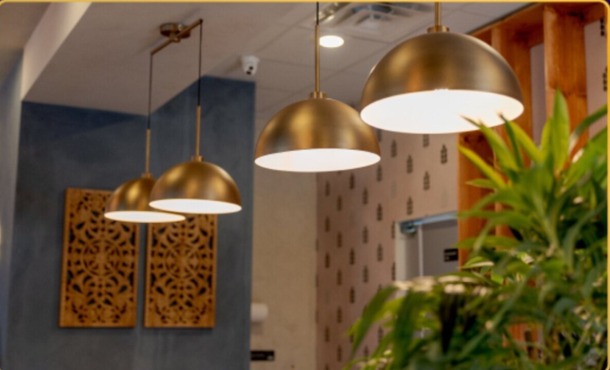 Brass pendant lights over the tables